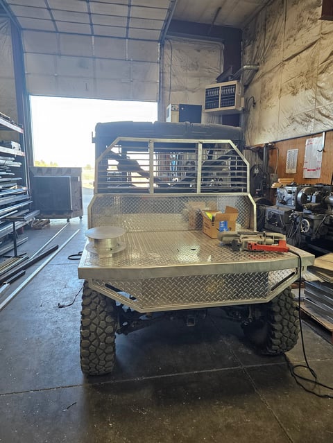 Custom truck bed with metal storage compartment and toolbox in garage workshop